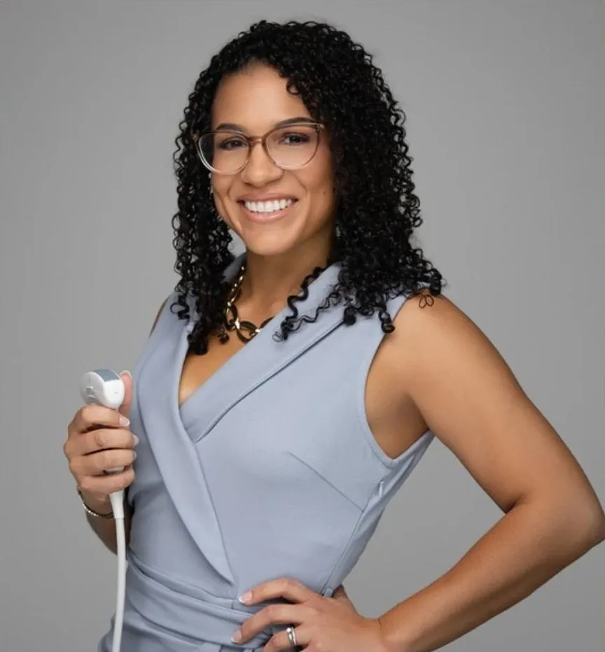 Massiel Valdez, RDMS, RVT, founder of Compassion Imaging Services, holding an ultrasound probe
